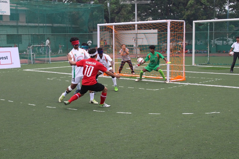 Laos player kick ball to goal post of team india