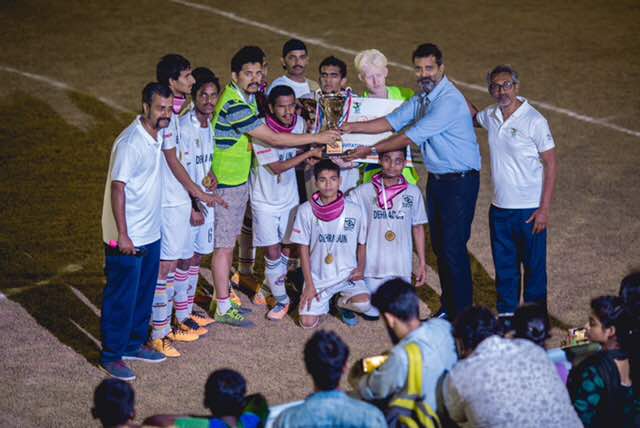 Actor Sijoy Varghese giving trophy to Dehradun players in Second All India Invitational Blind Football Tournament